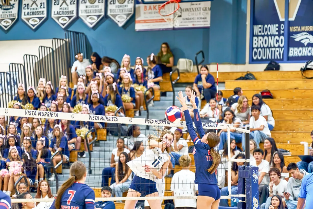 Vista Murrieta’s  Falynn Mitchell (11) spikes the ball past the defender for the point. Photo by Marcus Walker