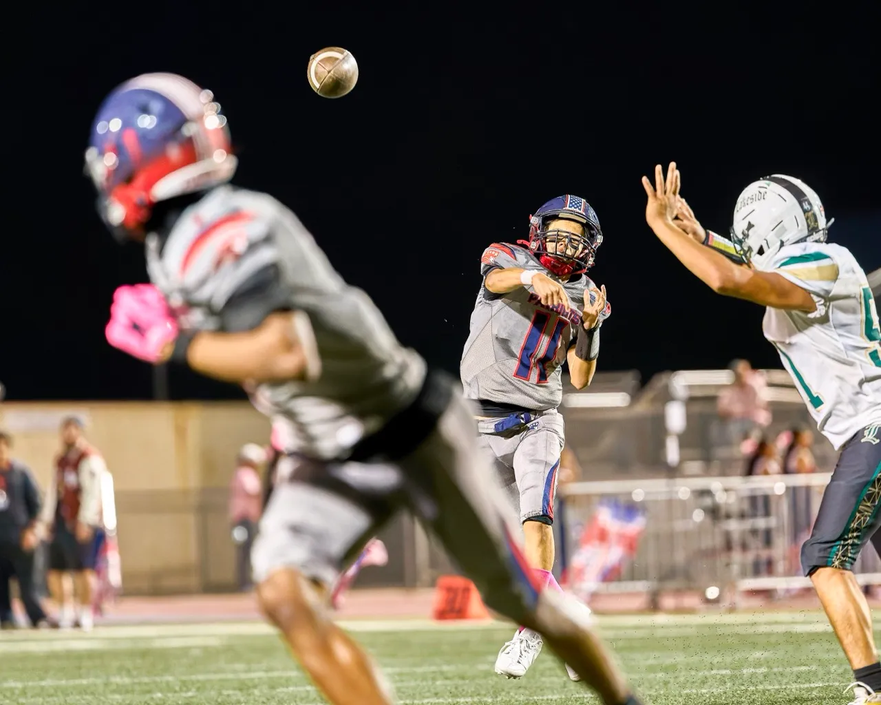 Heritage’s QB Noah Miltthon (11) slings the ball downfield to WR Drevion Burnett (1) on a completed pass. The Heritage Patriots defeated the Lakeside Lancers 20-14 Friday, Oct. 16.