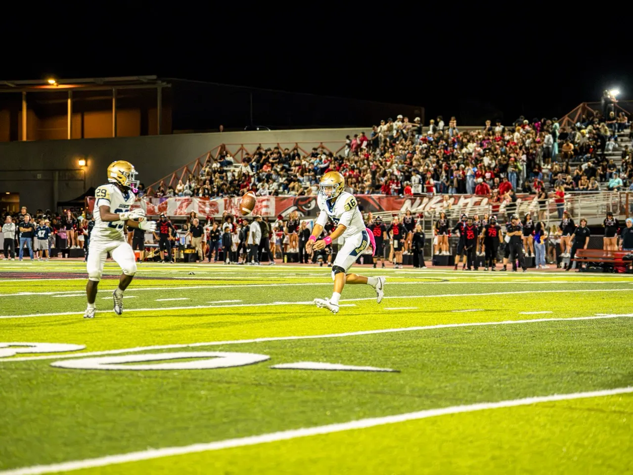 Vista Murrieta Quarterback, Levi Dean (16), tosses the football to Running Back Mason Booker (29) for a run downfield. The Murrieta Valley Nighthawks edged out the Vista Murrieta Broncos 28-20