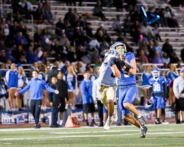 Norco’s WR Blake Wong (5) comes up with a catch deep down field while being smothered by a defender
