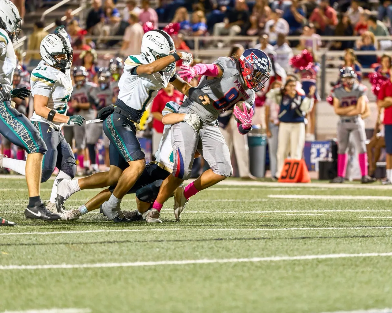 Heritage’s Nofotau Sili (81) drags a defender with him as he marches forward towards the first down marker. Photo by Marcus Walker