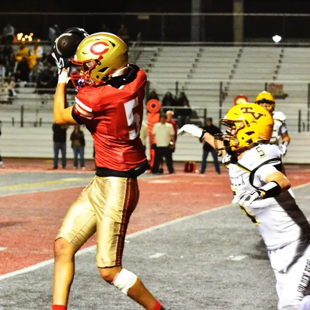 Corona’s Nico Mejia (left) snares a pass in front of Temecula Valley’s Justin Ruzzamenti (right) during the Golden Bears’ 41 – 27 victory over the Panthers. Credit: Photo by Gary Evans