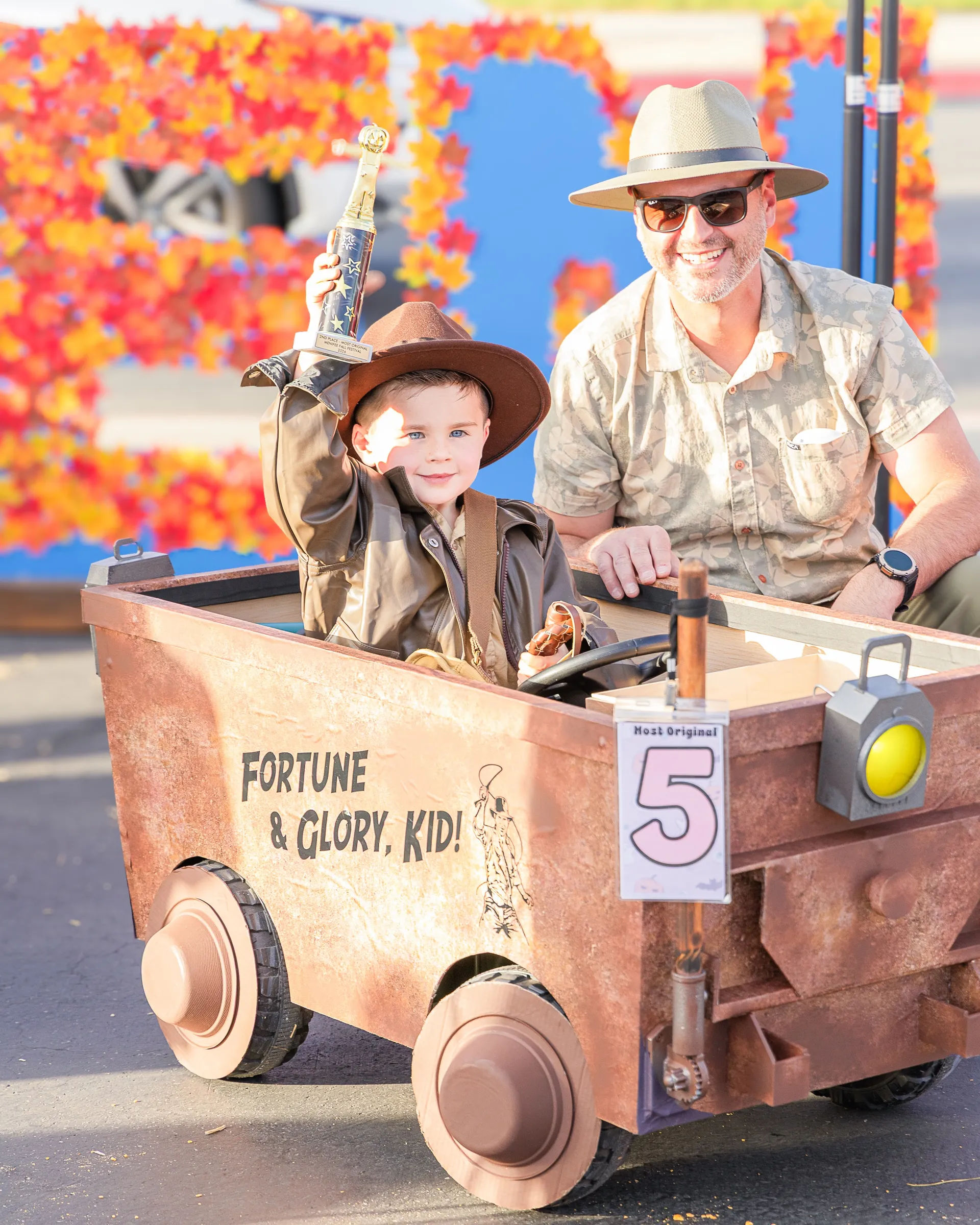Young Indiana Jones, aka, Atrus Ivanoff, age 4, rides in a homemade remote-controlled car that plays the Indiana Jones theme song and makes gear-shifting sounds, with his dad by his side, at the Fall Festival at Mt. San Jacinto Community College in Menifee on October 17.