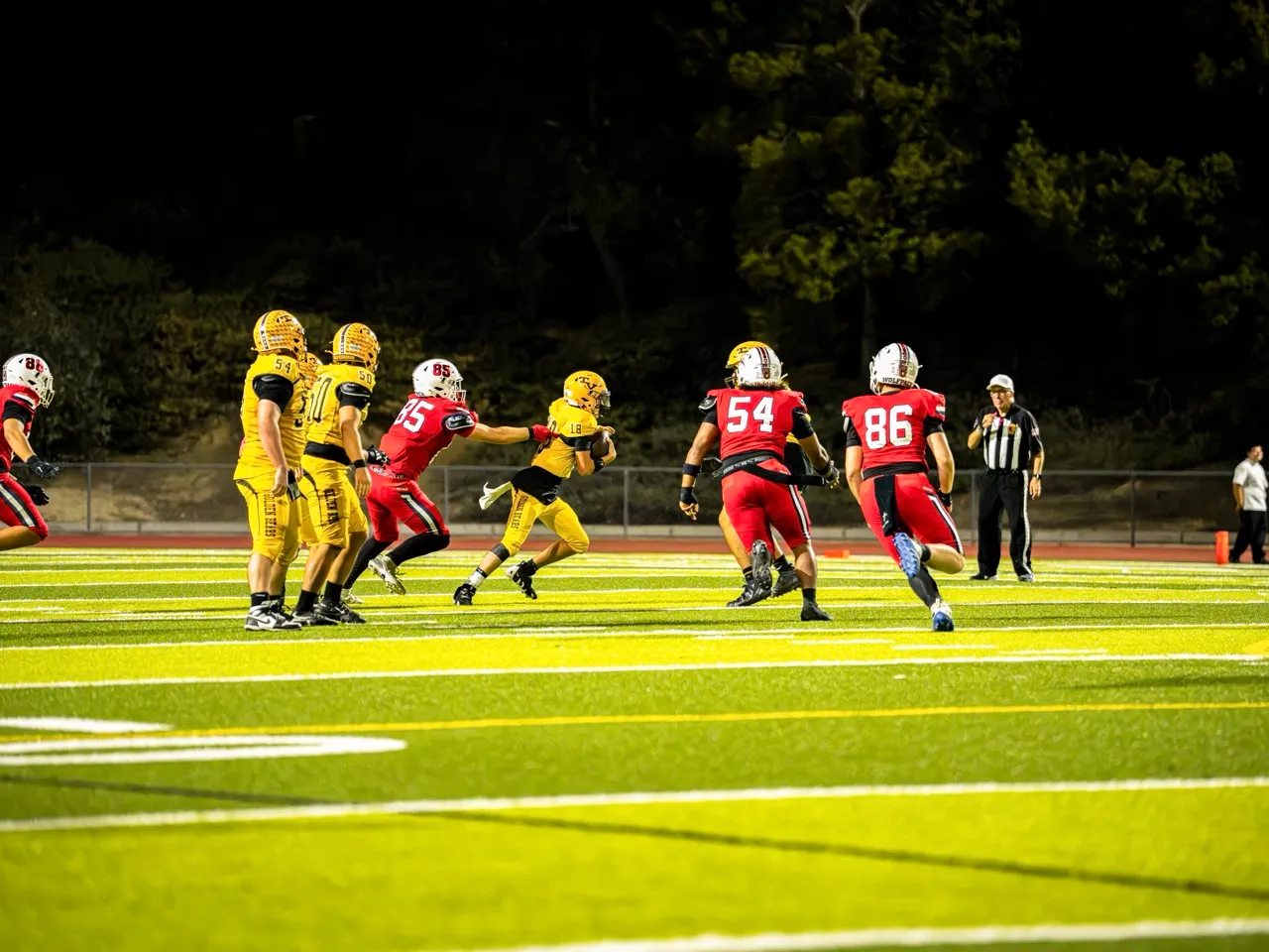 Temecula Valley Quarterback, Cayson Wicklas (18) escapes a Great Oak defender for a positive gain.