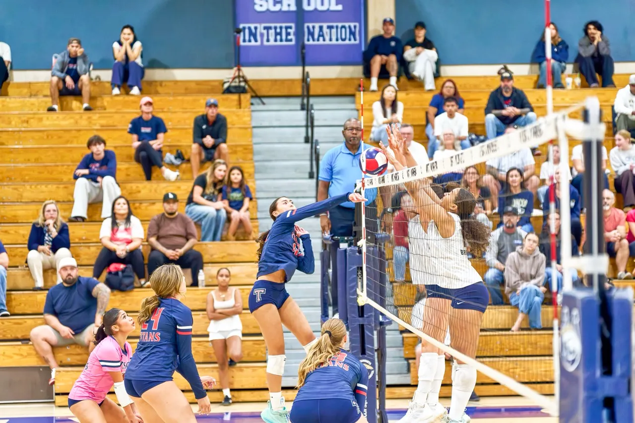 Tesoro’s Sydney Untalan (14) spike is blocked by Vista Murrieta’s wall. Photo by Marcus Walker
