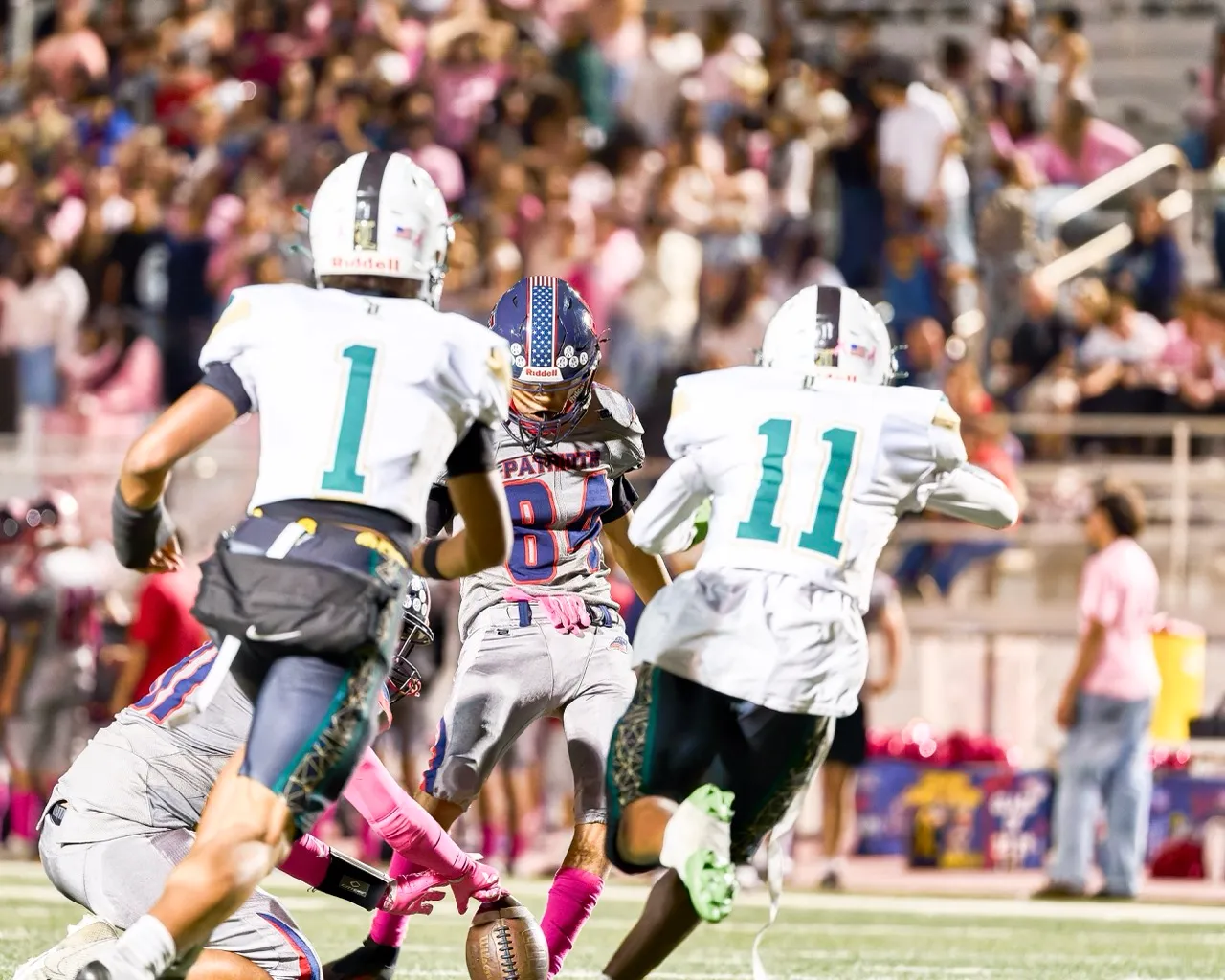 Heritage’s K Isaias Becerra (84) just gets the kick past two Lakeside defenders on a PAT. Photo by Marcus Walker